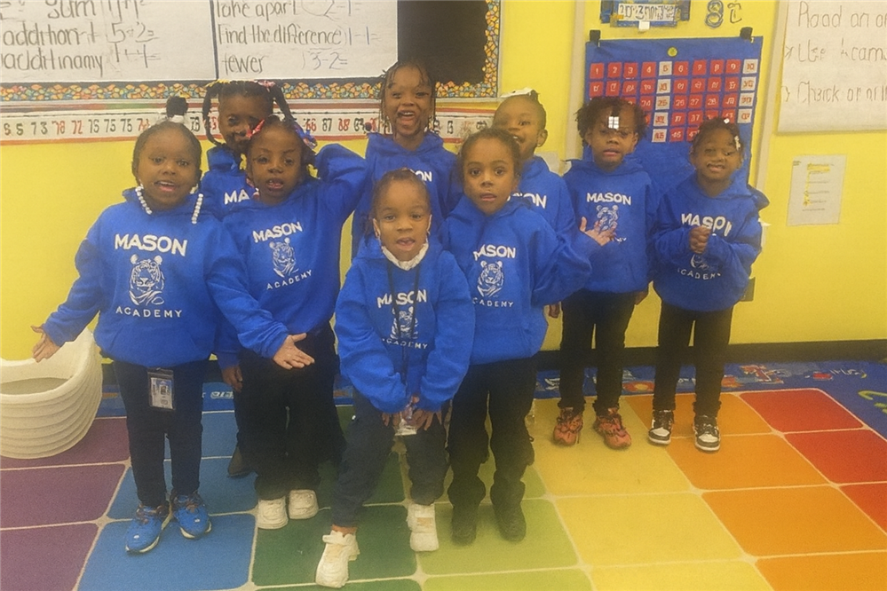  students posing with new mason hoody on